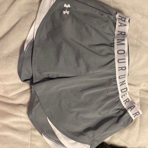 Grey and white Under Armour HeatGear athletic shorts.